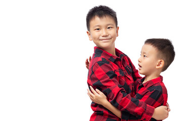 Brothers embracing, two boys wearing red team shirt isolated on white