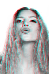 Studio portrait of sexy woman with messy hairstyle sending kiss to camera in red and blue color split effect. Image contains motion blur and noise. Lips is in camera focus. Futuristic looking style