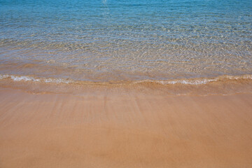 Blue ocean wave on sandy beach. Beach in sunset summer time. Beach landscape. Tropical seascape, calmness, tranquil relaxing sunlight.