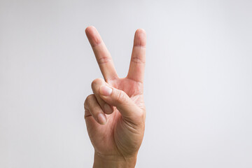 Victory or peace sign or number two hand sign. On white background.