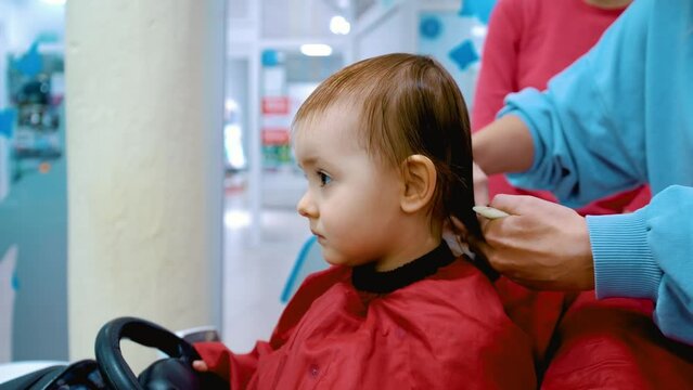 regrown haircut. Kid in a beauty salon getting his hair cut