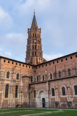 Fototapeta na wymiar Scenic vertical landscape view of ancient landmark St Sernin basilica in the pink city of Toulouse, France