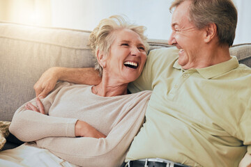 Elderly couple, laugh and hug on sofa in happy relationship, silly face or bonding together at...