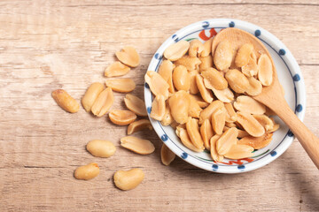 Peanuts in a cup on wooden background