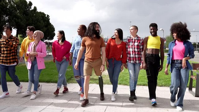 diverse young people enjoying outdoors on a sunny day, group of multiracial and different gender friends, - concept of social diversity and friendship -