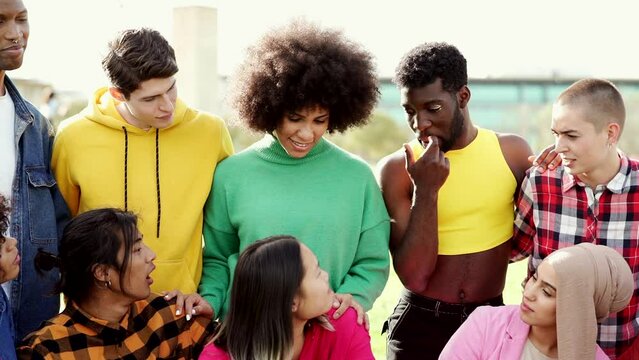 Diverse multi ethnic group of people having fun outdoors - non binary person, gender freedom -