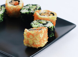 Sushi and rolls. the set is served on a black plate