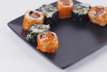 set of Sushi rolls on black plate