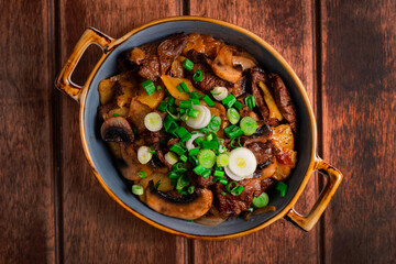 mushrooms with meat and vegetables on a wooden background