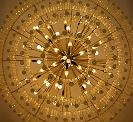 Crystal lamp giving a yellow glow to the ceiling.