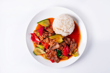meat with vegetables and rice on a white background