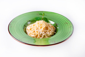pasta sprinkled with cheese, mint on a white background