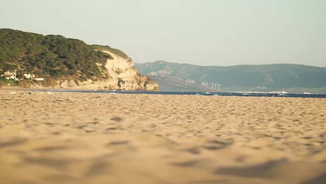 Ground level view of the beach with golden sand at Cadiz in Spain late evening with amazing light