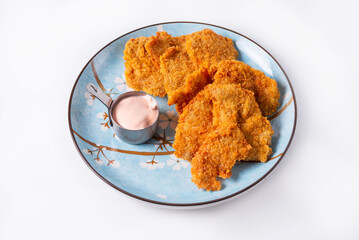 fried chicken meat with sauce on a white background