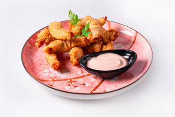 fried chicken meat with sauce on a white background