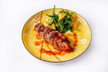 sliced meatloaf with salad on a white background