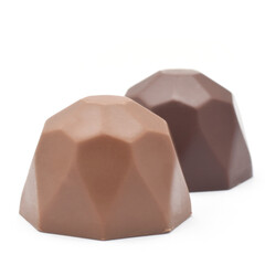 Belgian milk and dark chocolate candies in diamond shape closed up isolated on white