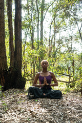 woman meditating in the forest