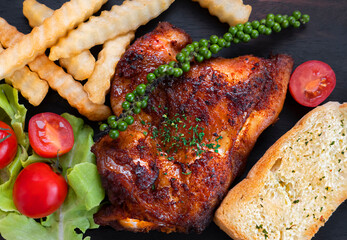 Chicken grilled steak with French fries and toast bread. 