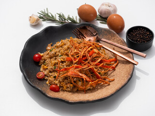 Stir-fried rice with fried crab sticks on white background.