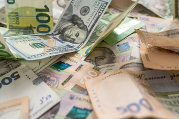A lot of different money hryvnia euro and dollar bills on desk. exchange or saving concept