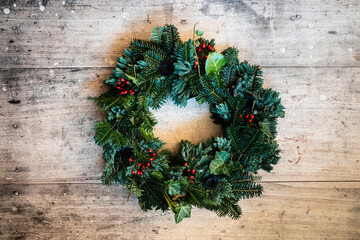 Studio shot of wreath made of spruce, juniper, ivy and rose hips