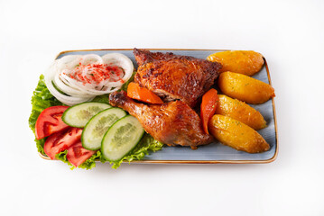 stewed chicken meat with potatoes and fresh tomatoes, cucumbers and onions on a white background