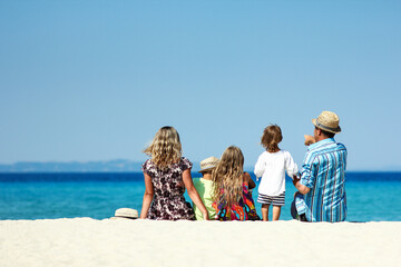 family on the sand by the sea