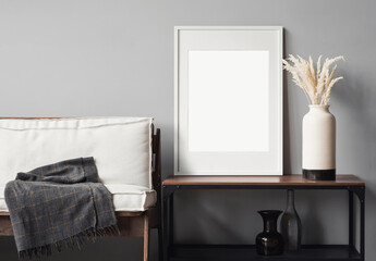 Blank picture frame mockup on gray wall. Modern living room design. View of scandinavian rustic...