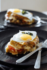 tasty sandwich with cheese, tomatoes and fried eggs