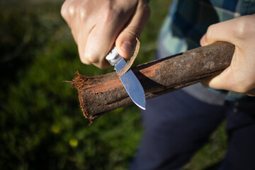 Person Feathering Wood with Multitool Pocket Knife