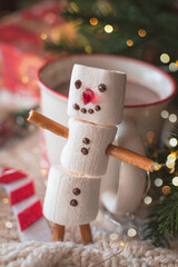 Red and white cup with hot chocolate with  marshmallow snowman.  Сhristmas and new year decoration.