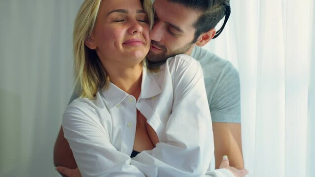 Caucasian young couple spend free leisure time together in living room