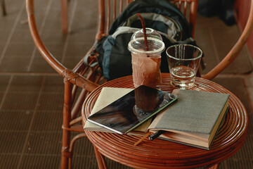 Writing journal and digital tablet on a table in a cafe showing the lifestyle of a freelancer, digital nomad and remote work