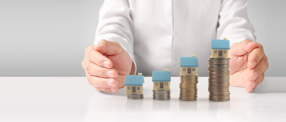 Fototapeta premium House Residential Structure in hand ,model house and coin