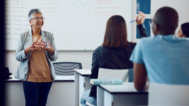 Physics, Teaching And Teacher In A Class With Students, Studying Molecules And Communication In Classroom At School. Chemistry, Learning And Woman With Children For Education On An Atom At College