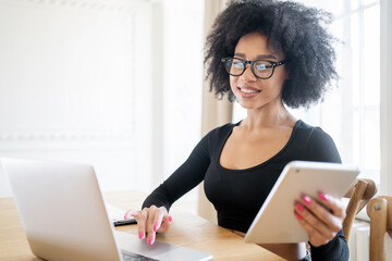 A freelance woman working online in the office uses a laptop coworking space.