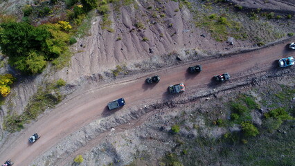Aerial drone view of ATV quads on a dirt trail in forests. Off-road group team club enthusiasts...