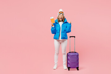 Snowboarder fun woman in blue suit goggles mask hat ski jacket hold passport ticket bag isolated on...