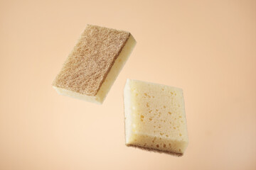 Natural dishwashing sponge over beige background. Eco friendly housework objects.