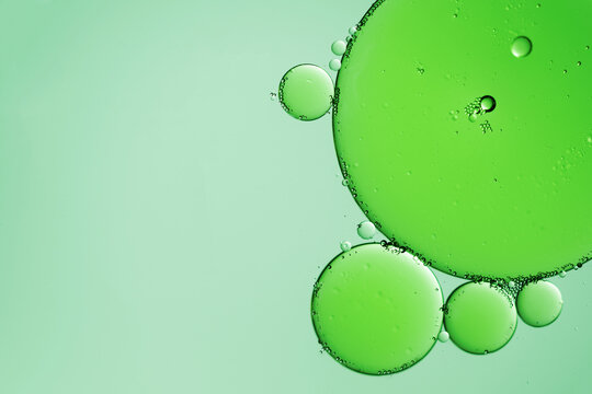 Oil droplets on water surface background. Abstract green background. - Powered by Adobe