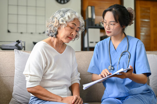 A 60-year-old Elderly Retire Woman And Her Doctor Having A Serious Talk