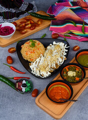 Chilaquiles with rice Mexican sauces chili peppers and cherry tomatoes side view