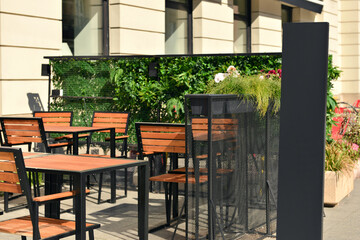 Outdoor cafe with beautiful plants and comfortable furniture