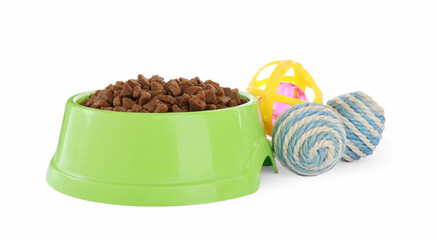 Different toys and bowl of food for pet isolated on white