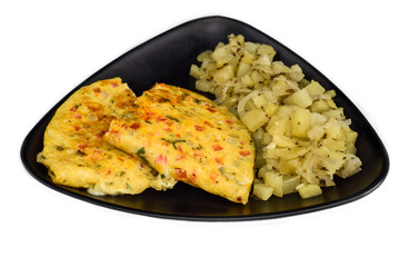 Mexican omelet with potato on black plate isolated on white background top view