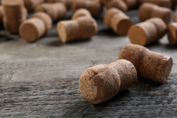 Sparkling wine bottle corks on wooden table, closeup. Space for text