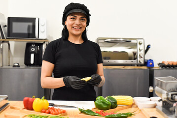 Mexican woman laughing during cooking tacos in the kitchen