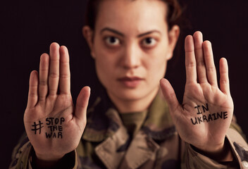 Ukraine, war and stop with woman soldier showing her hands or palms in protect to military...
