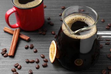 Turkish coffee in glass cezve and cup on grey wooden table. Space for text